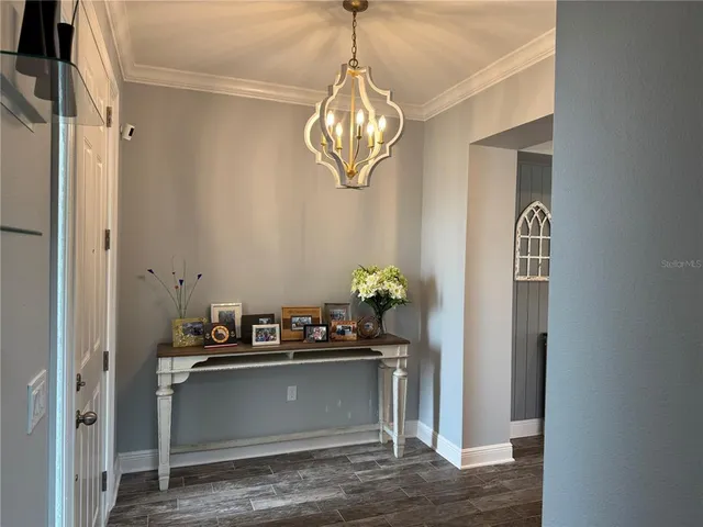 a kitchen with a refrigerator and a chandelier