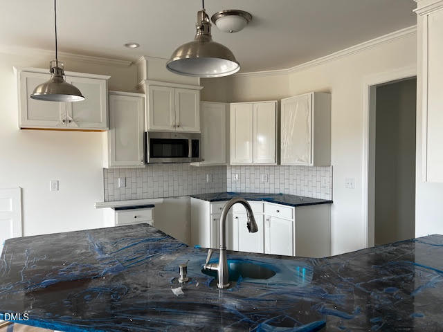 15 Alex Acres Way Selma, NC 27576 - Photo 3 of 11 a kitchen with granite countertop a stove a sink and a microwave