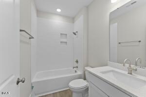 2760 River Meadow Spring Hope, NC 27882 - Photo 32 of 42 a bathroom with a granite countertop sink a toilet and shower