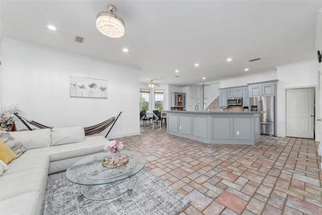 a living room with furniture and kitchen view