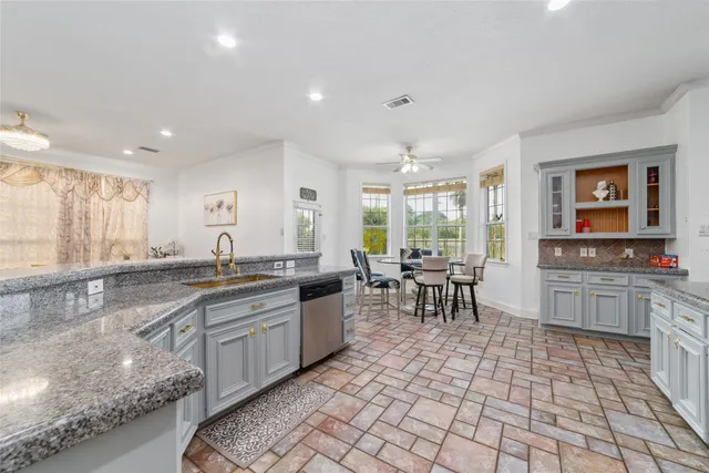 a kitchen with lots of counter top space and dining table