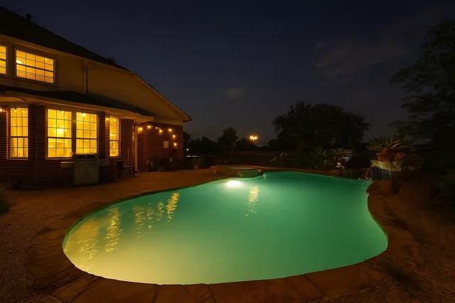 a view of a swimming pool with an outdoor seating area
