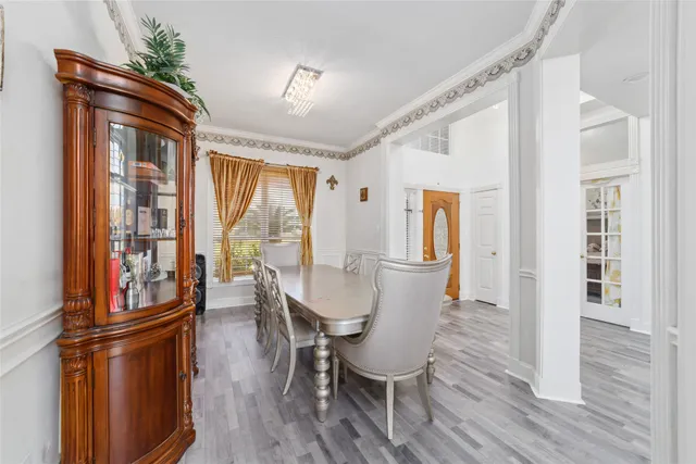 a dining room with furniture window and wooden floor