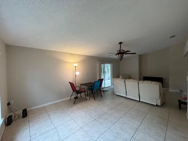 a view of a livingroom with furniture and a window