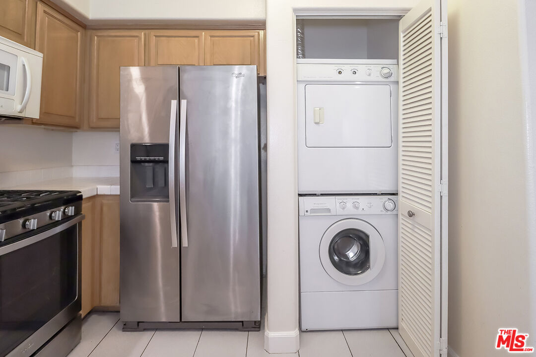 11920 Goshen Avenue, Unit 102 Los Angeles, CA 90049 - Photo 15 of 39 a white refrigerator freezer and a stove sitting inside of a kitchen