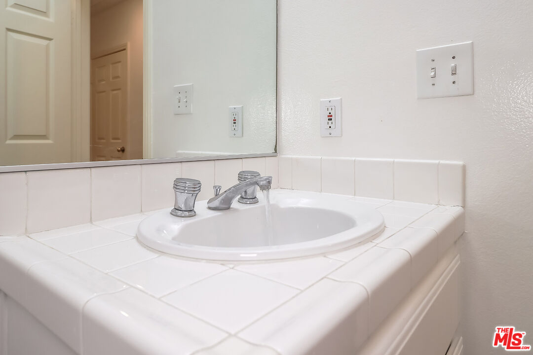 11920 Goshen Avenue, Unit 102 Los Angeles, CA 90049 - Photo 18 of 39 a white bath tub sitting next to a white sink