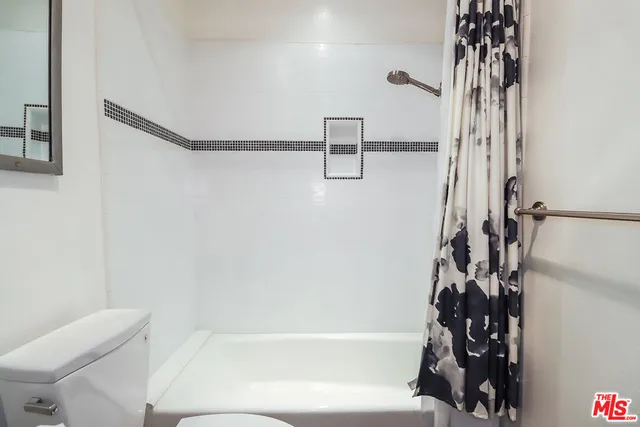 a bathroom with double vanity sinks and a mirror