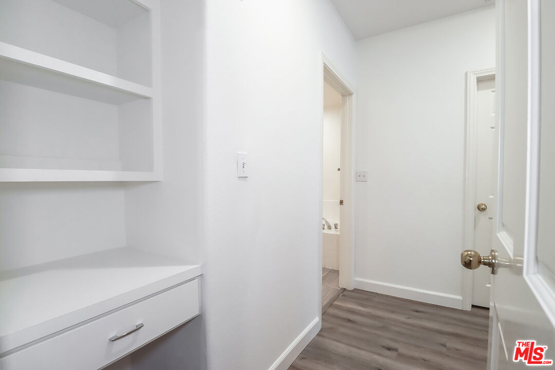 11920 Goshen Avenue, Unit 102 Los Angeles, CA 90049 - Photo 25 of 39 a view of an empty room with wooden floor
