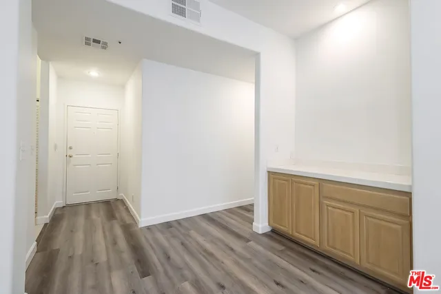 a view of hallway with wooden floor