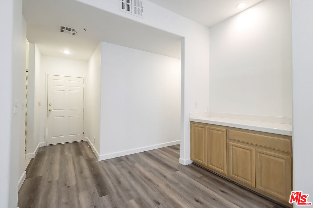 11920 Goshen Avenue, Unit 102 Los Angeles, CA 90049 - Photo 6 of 39 a view of hallway with wooden floor
