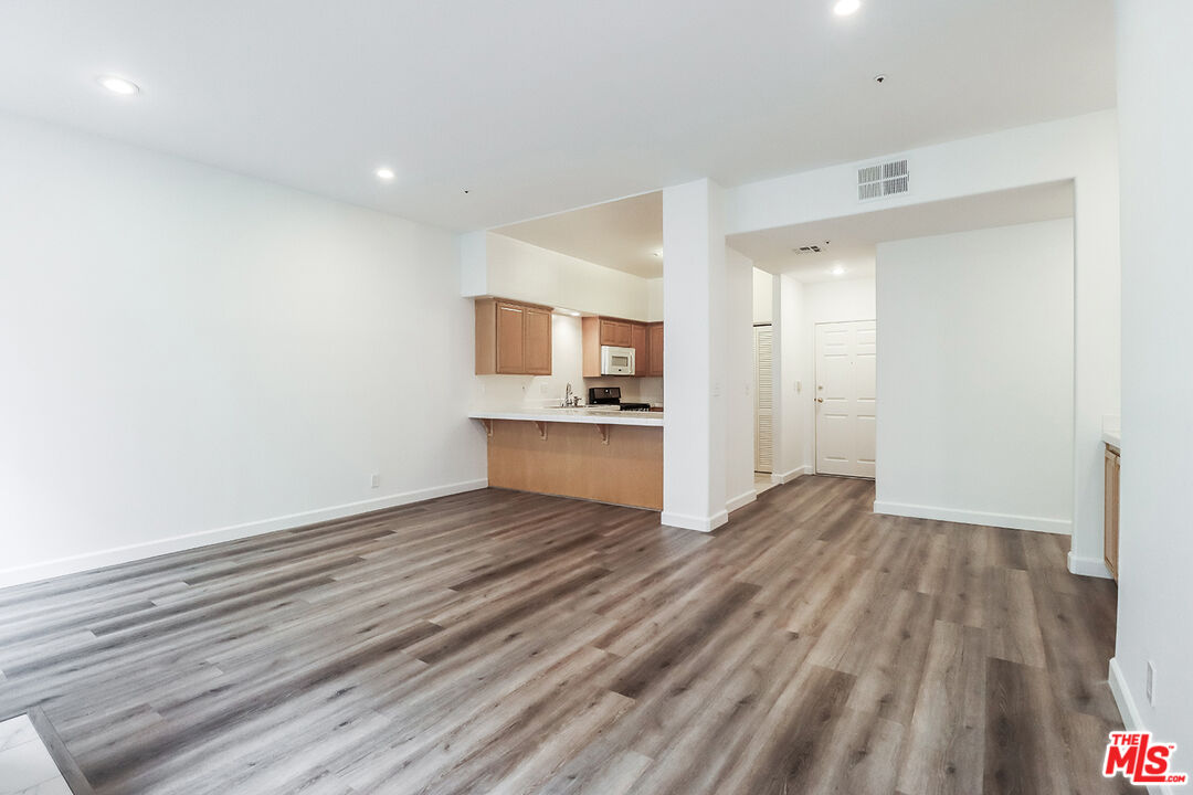 11920 Goshen Avenue, Unit 102 Los Angeles, CA 90049 - Photo 10 of 39 a view of a kitchen with wooden floor and electronic appliances