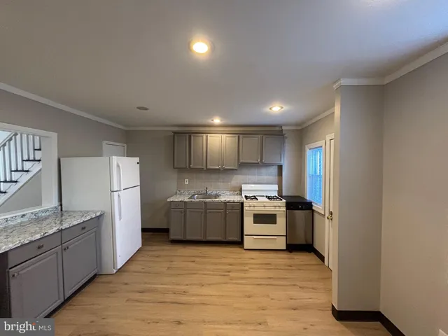 a kitchen with refrigerator and cabinets