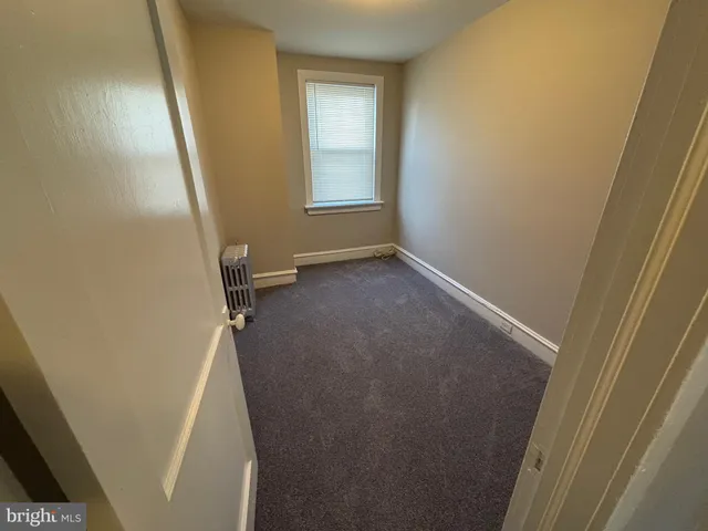 a view of a room with rack on the wall and a window