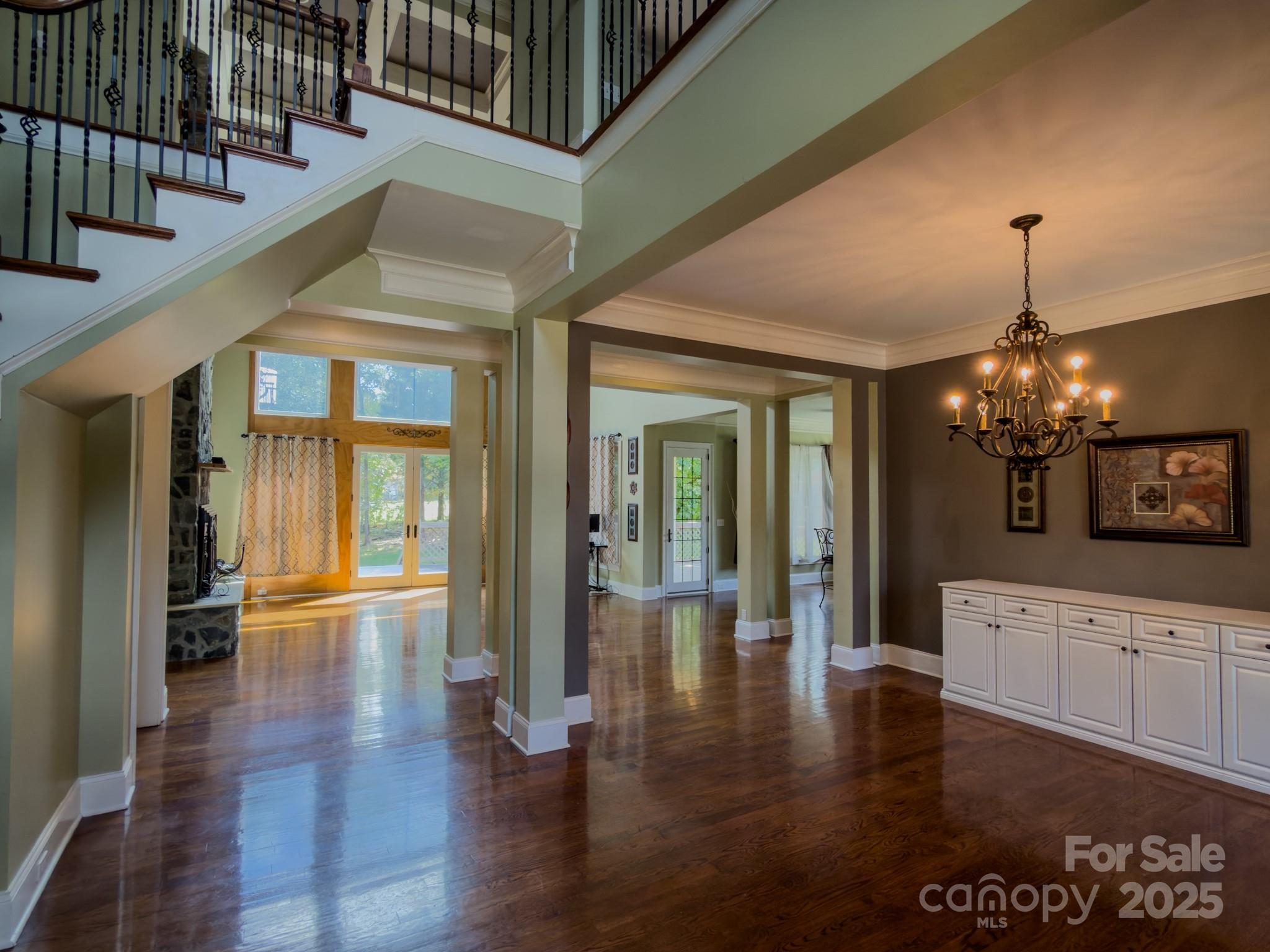 1132 Mt Holly-Huntersville Road Charlotte, NC 28214 - Photo 11 of 43 a view of a hallway with the wooden floor and chandelier
