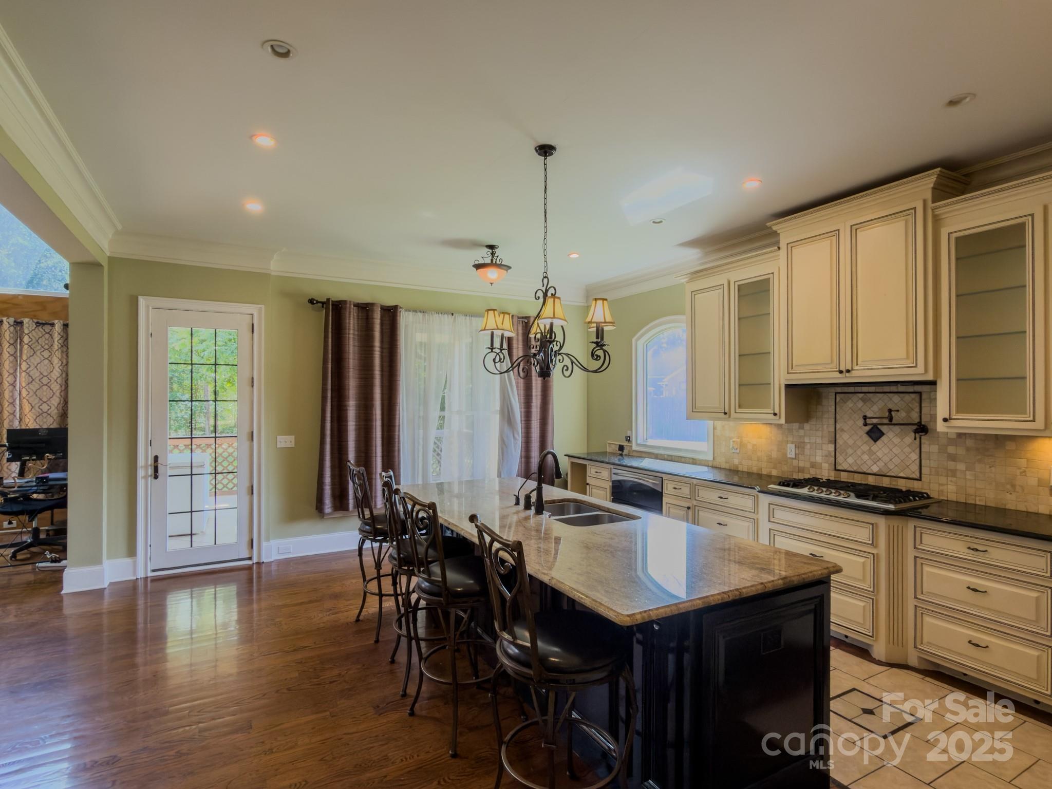 1132 Mt Holly-Huntersville Road Charlotte, NC 28214 - Photo 12 of 43 a kitchen with stainless steel appliances granite countertop a sink a stove and a wooden floors