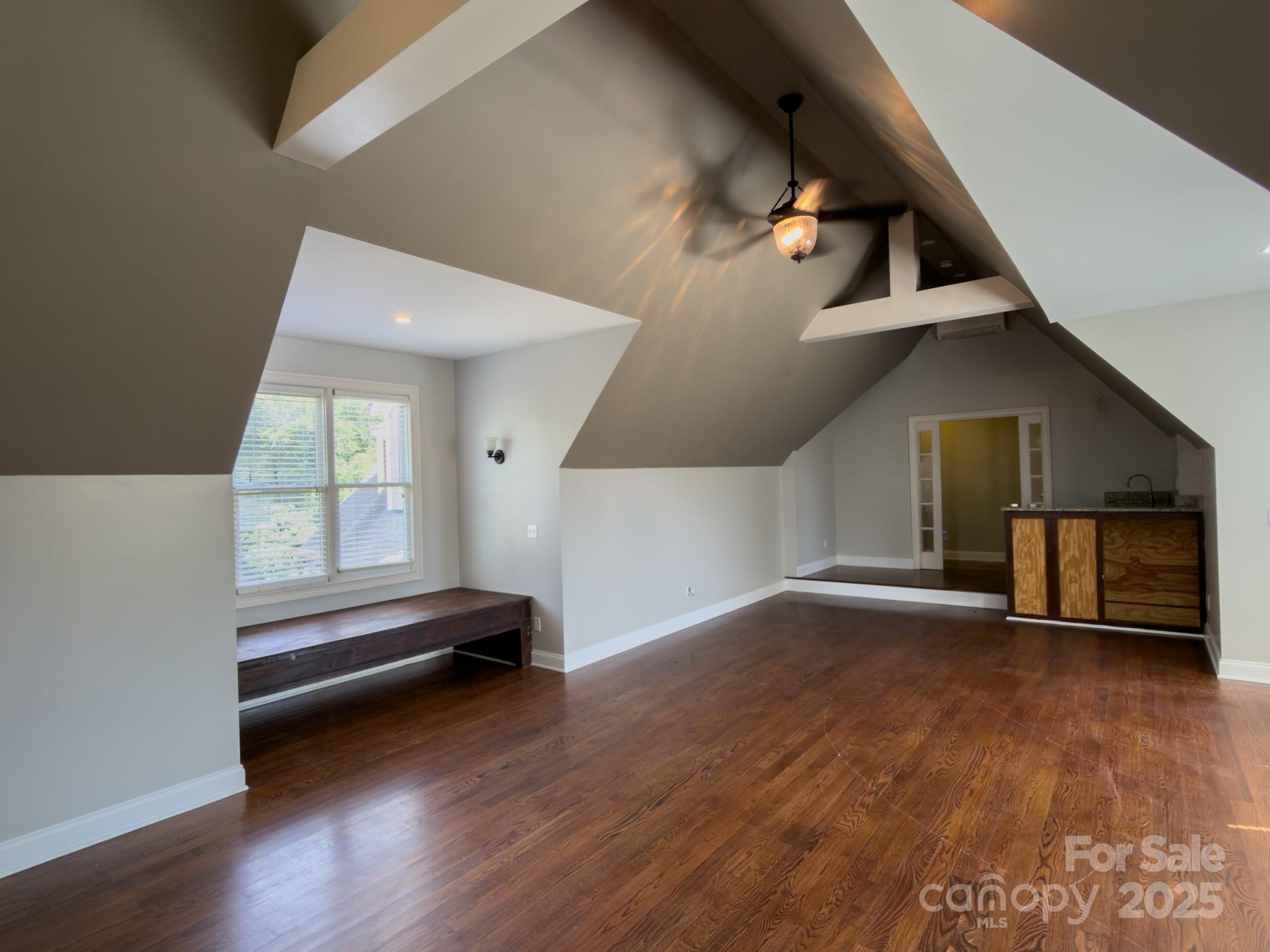 1132 Mt Holly-Huntersville Road Charlotte, NC 28214 - Photo 16 of 43 wooden floor in an empty room with a window