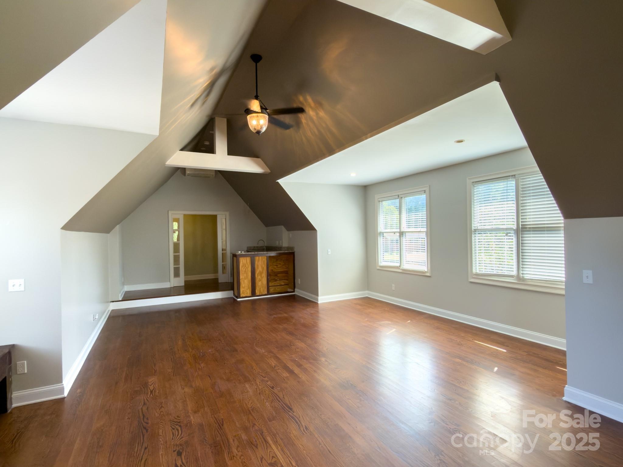 1132 Mt Holly-Huntersville Road Charlotte, NC 28214 - Photo 17 of 43 an empty room with wooden floor and windows
