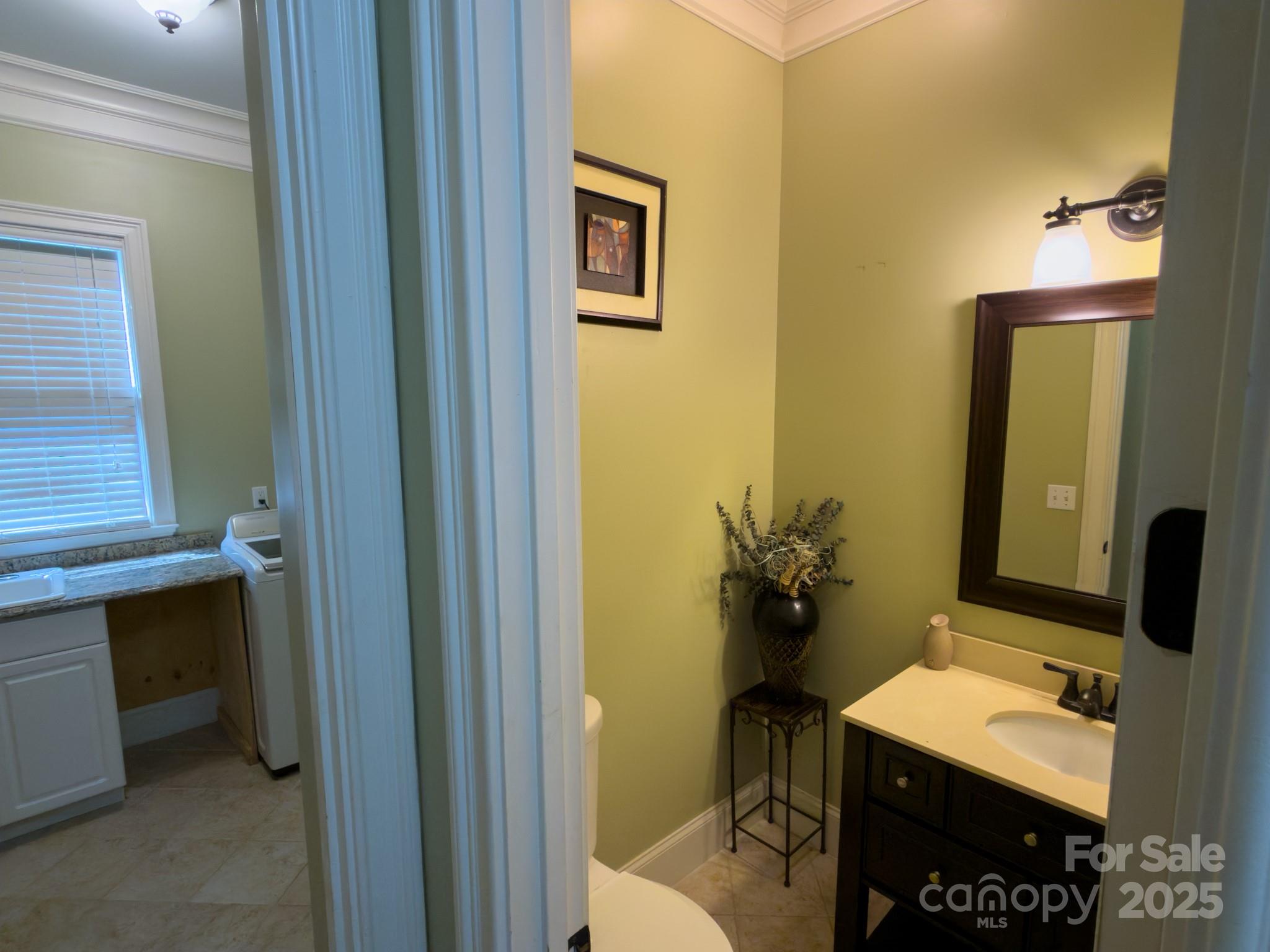 1132 Mt Holly-Huntersville Road Charlotte, NC 28214 - Photo 32 of 43 a bathroom with a sink vanity mirror and toilet