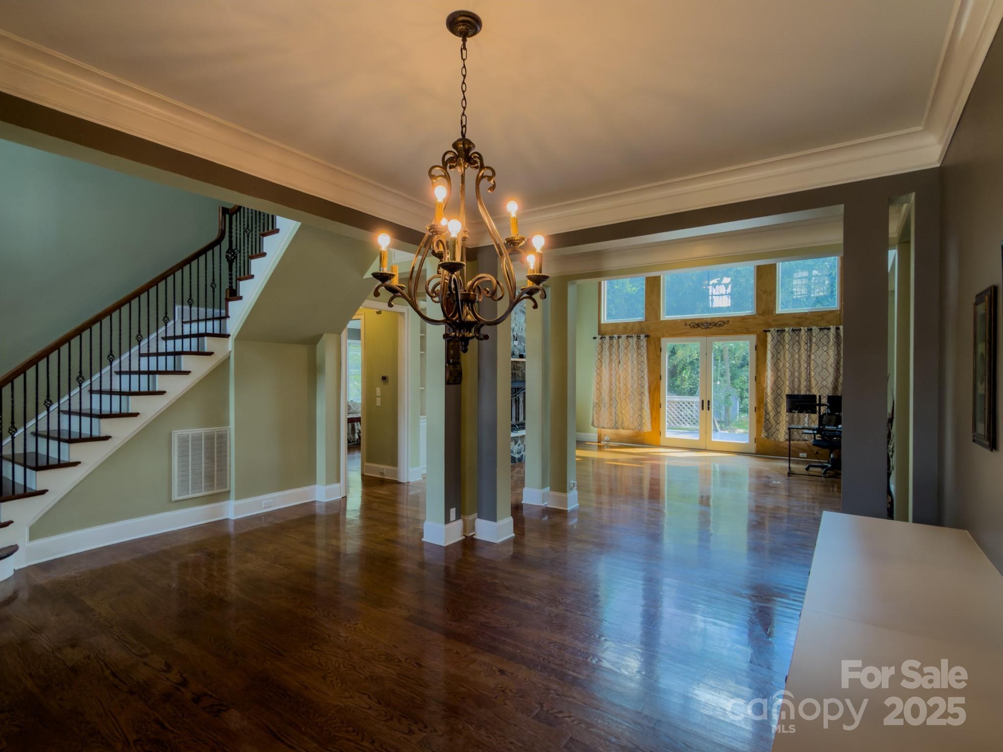 1132 Mt Holly-Huntersville Road Charlotte, NC 28214 - Photo 7 of 43 a view of a room with wooden floor chandelier and windows