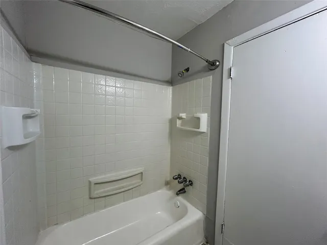 a bathroom with a shower and a bath tub