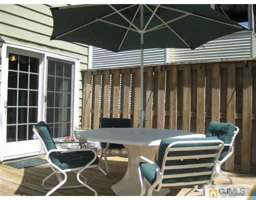 196 North Hill Road Colonia, NJ 07067 - Photo 3 of 10 a blue and white table and chairs under an umbrella
