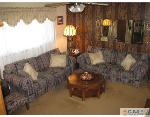 196 North Hill Road Colonia, NJ 07067 - Photo 5 of 10 a living room with furniture and a clock