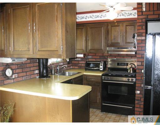 196 North Hill Road Colonia, NJ 07067 - Photo 7 of 10 a kitchen with stainless steel appliances granite countertop a stove a sink and a microwave