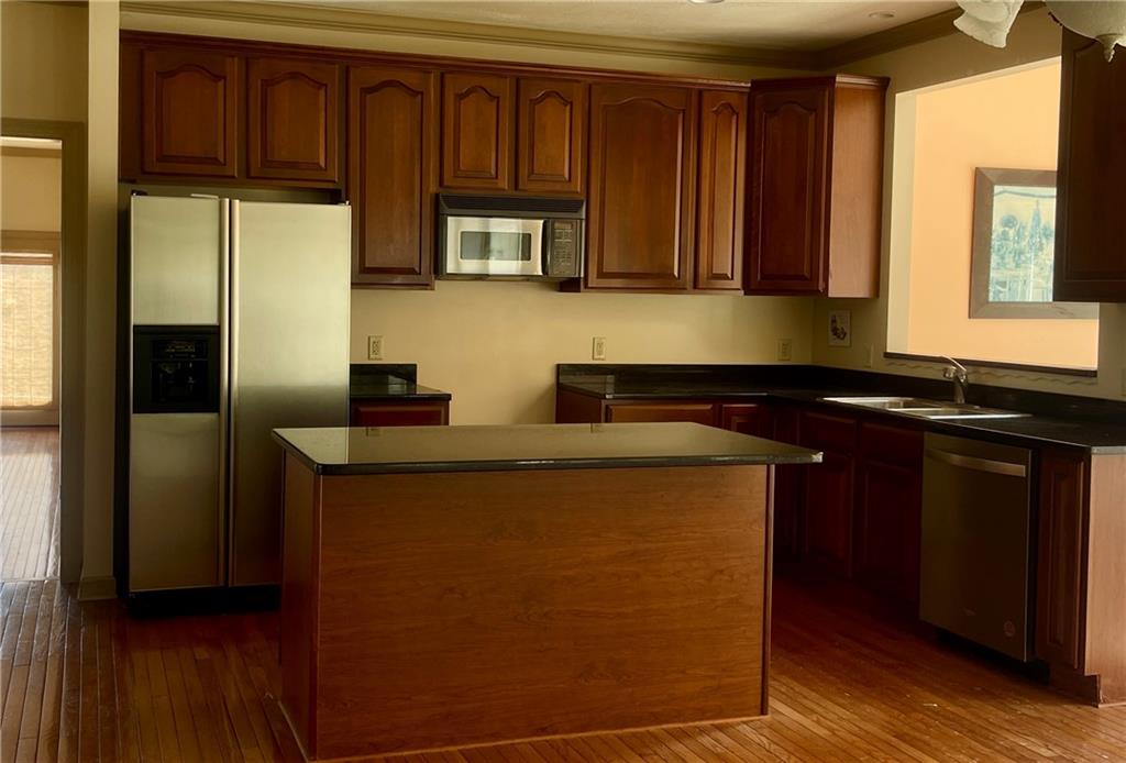 1849 Dutch Ridge Road Ellwood City, PA 16117 - Photo 2 of 17 a kitchen with granite countertop wooden cabinets and a refrigerator