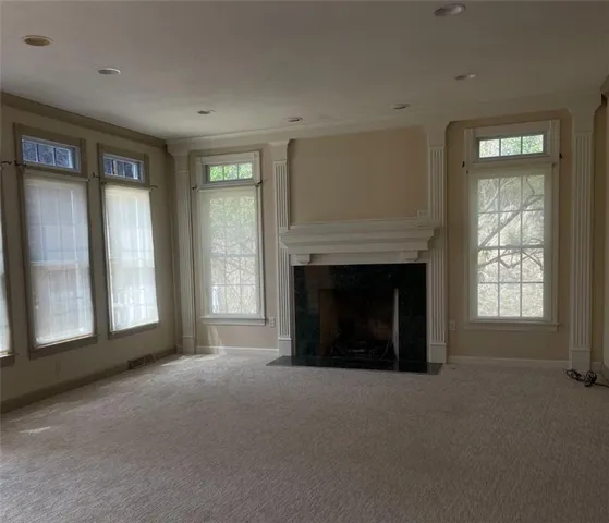 a living room with a fireplace and a large window