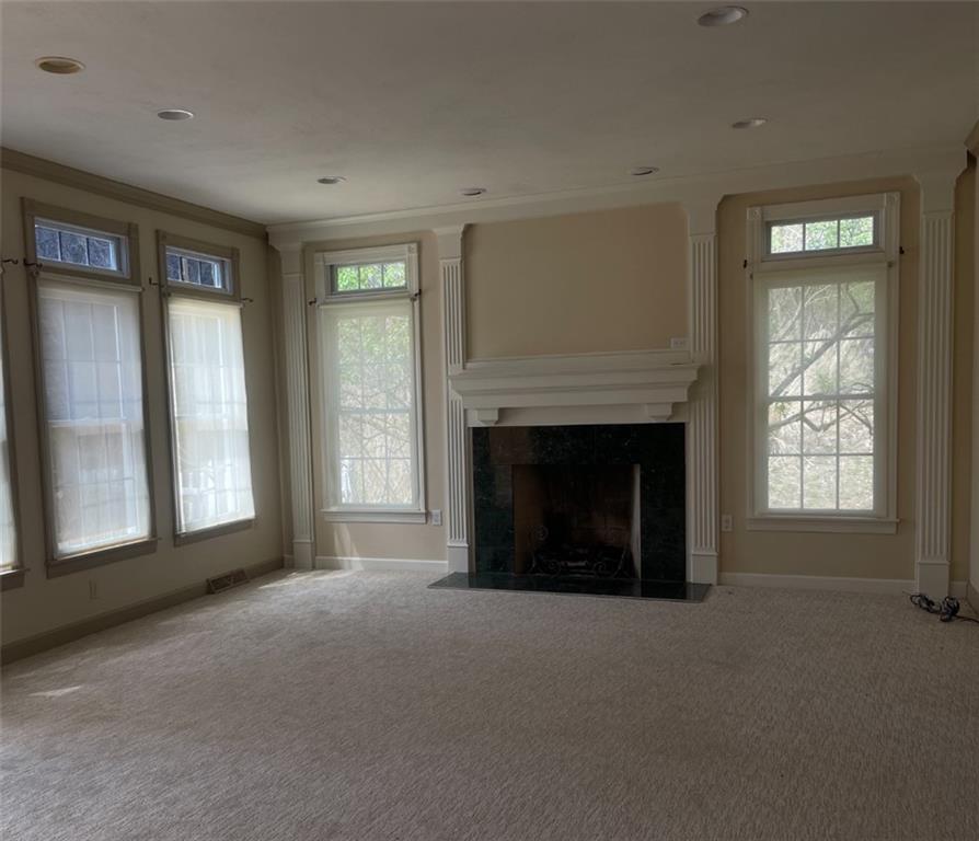 1849 Dutch Ridge Road Ellwood City, PA 16117 - Photo 4 of 17 a living room with a fireplace and a large window