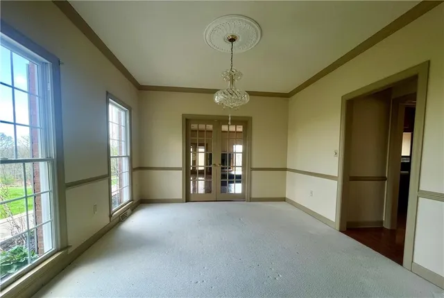 a view of a hallway with a chandelier