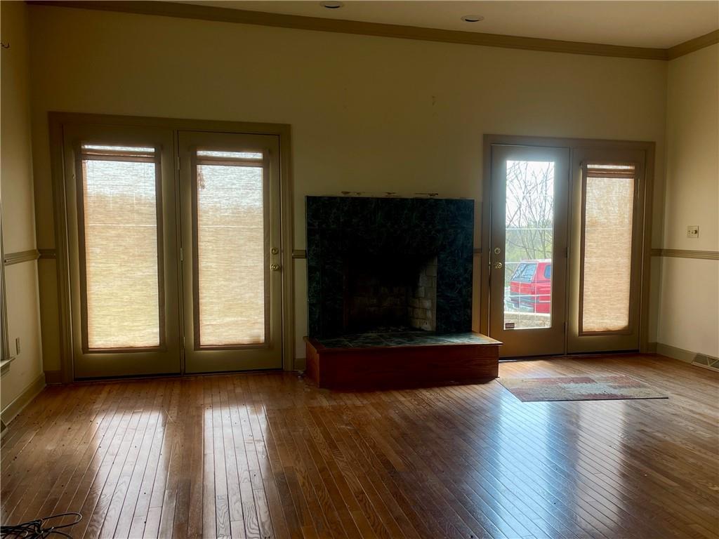 1849 Dutch Ridge Road Ellwood City, PA 16117 - Photo 8 of 17 a view of a livingroom with wooden floor and a fireplace