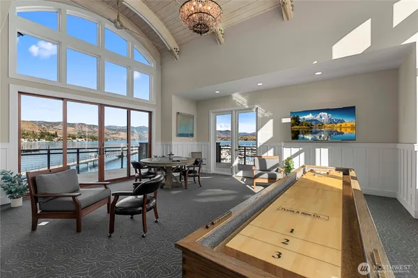 a living room with furniture pool table and a large window