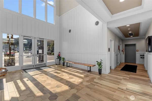 a living room with furniture a rug and a large window