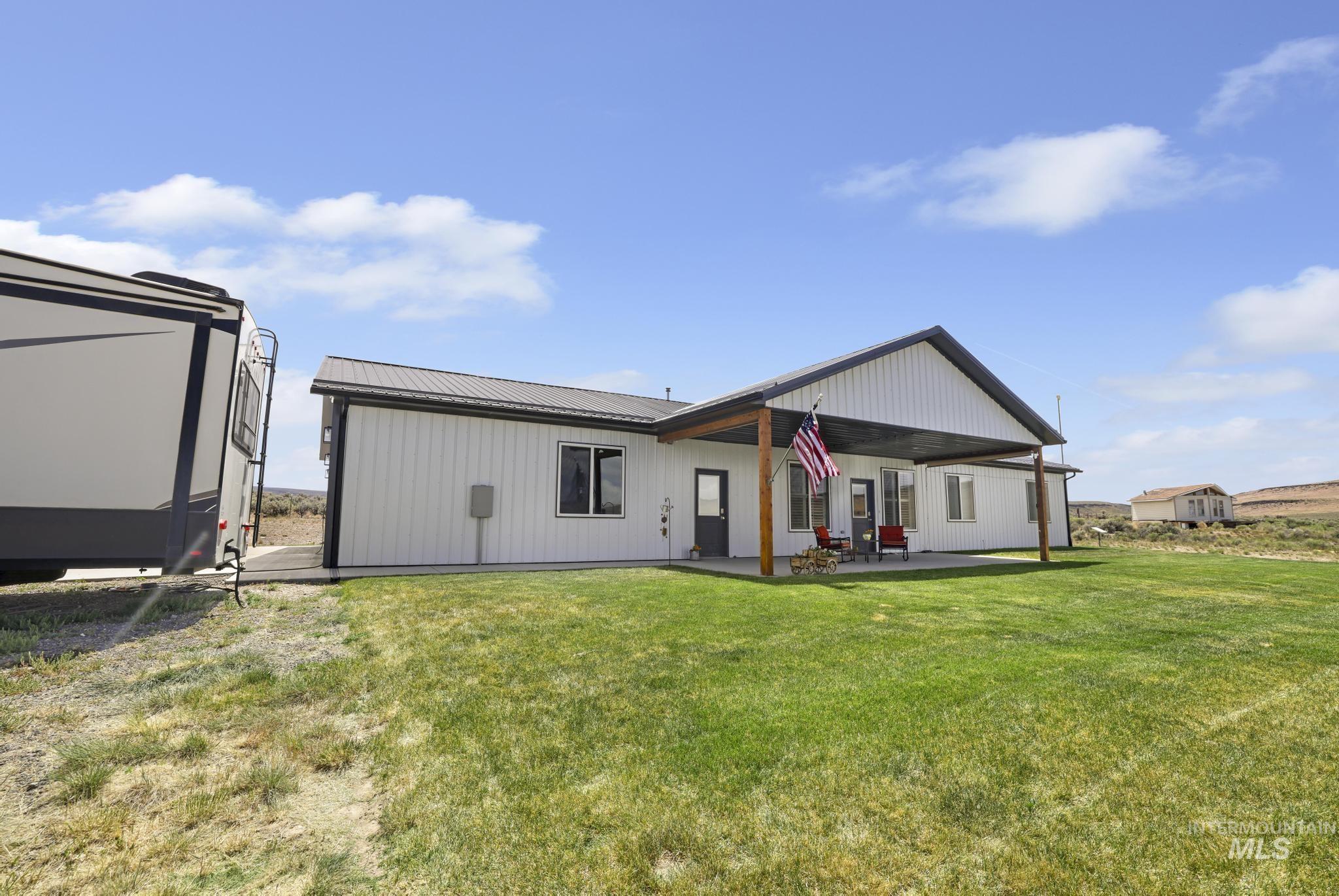 758 Cedar Crk Road Rogerson, ID 83302 - Photo 32 of 50 Modern single-story residence featuring white vertical siding and a dark metal roof