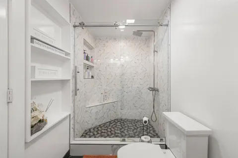 an aerial view of a house with a yard basket ball court and outdoor seating
