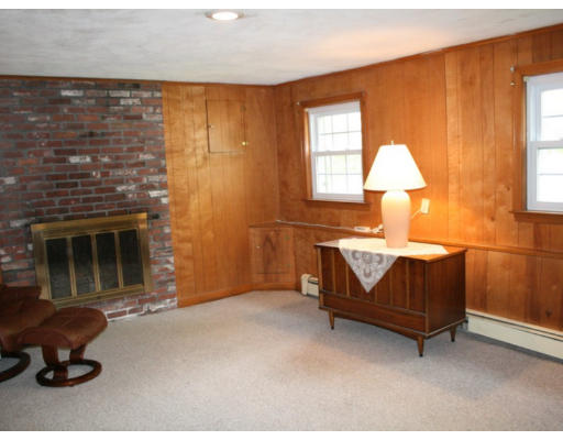 35 Colonial Drive Reading, MA 01867 - Photo 11 of 14 a living room with furniture a window and a fireplace