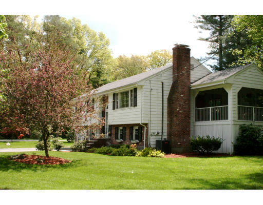 35 Colonial Drive Reading, MA 01867 - Photo 2 of 14 a front view of a house with a garden