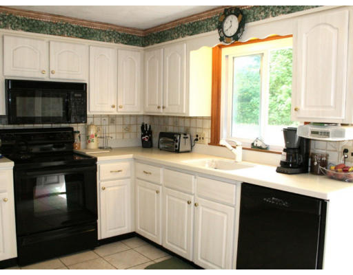 35 Colonial Drive Reading, MA 01867 - Photo 6 of 14 a kitchen with granite countertop a sink stainless steel appliances and white cabinets