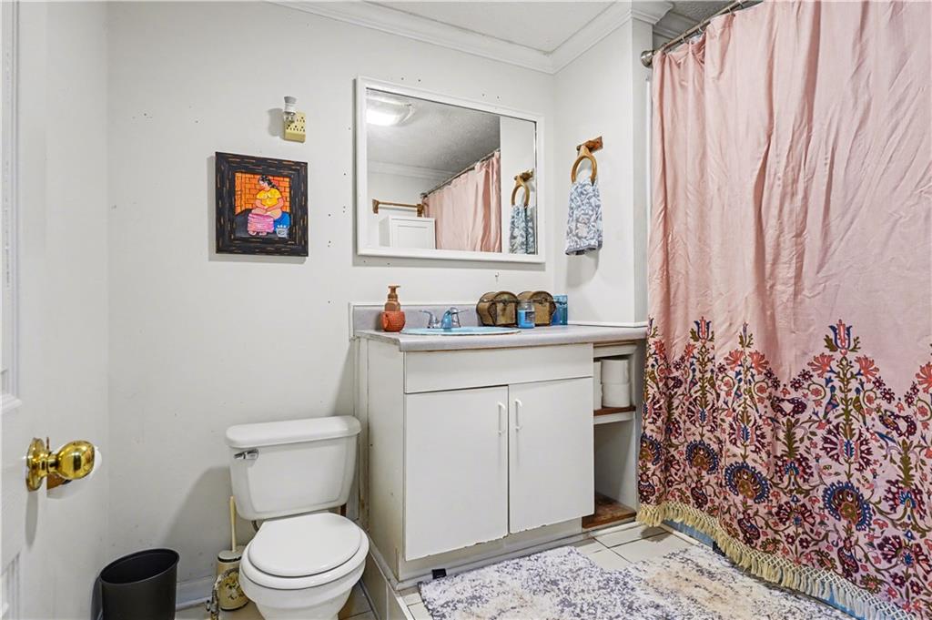 267 Macon Street Monticello, GA 31064 - Photo 14 of 28 a bathroom with a toilet sink and mirror