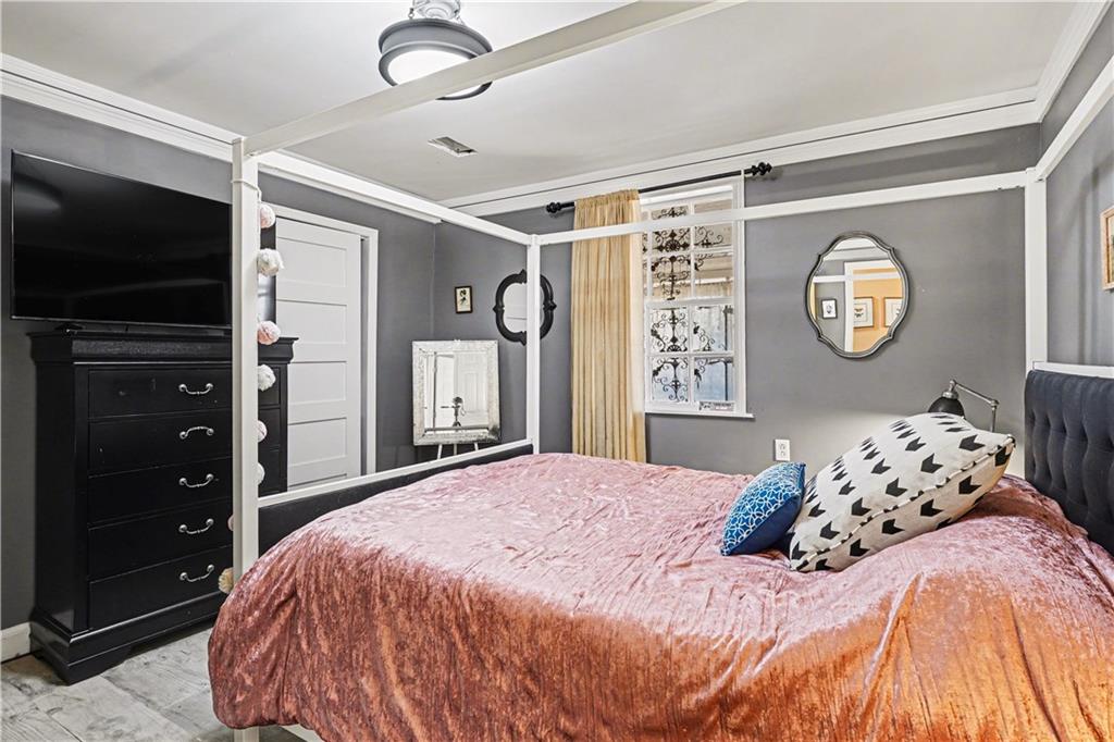 267 Macon Street Monticello, GA 31064 - Photo 16 of 28 a bedroom with a large bed and a tv