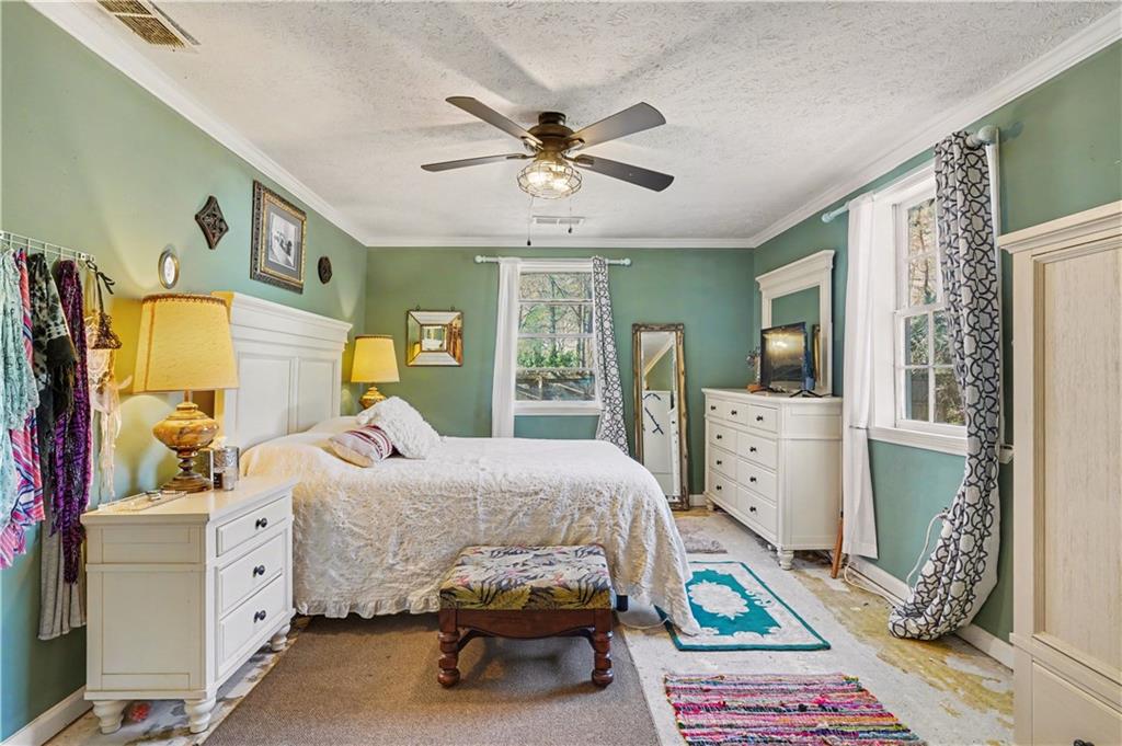 267 Macon Street Monticello, GA 31064 - Photo 17 of 28 a bedroom that has a bed and a dresser in it