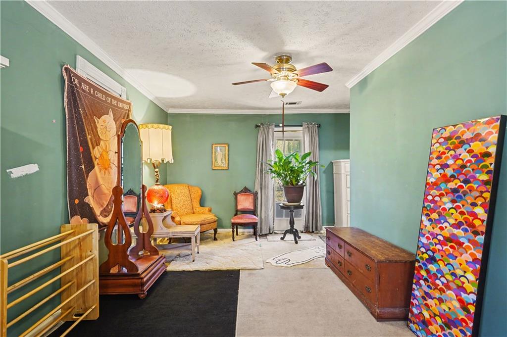 267 Macon Street Monticello, GA 31064 - Photo 19 of 28 a living room with furniture and a chandelier