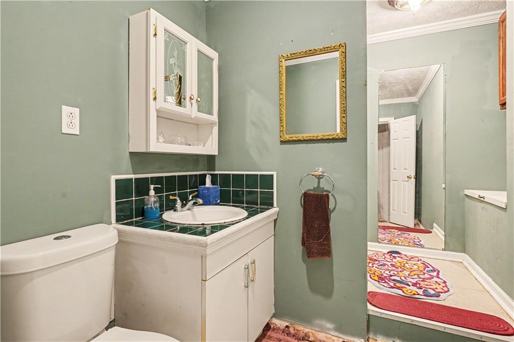 267 Macon Street Monticello, GA 31064 - Photo 21 of 28 a bathroom with a sink and a mirror
