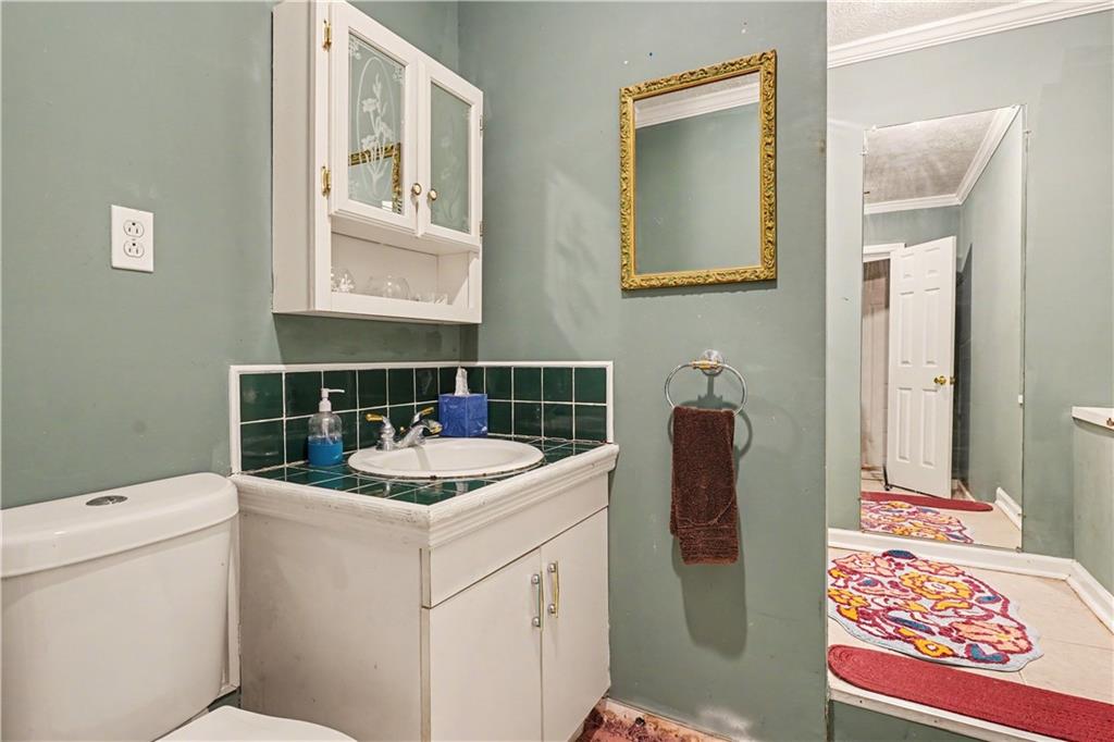 267 Macon Street Monticello, GA 31064 - Photo 22 of 28 a bathroom with a sink and a toilet