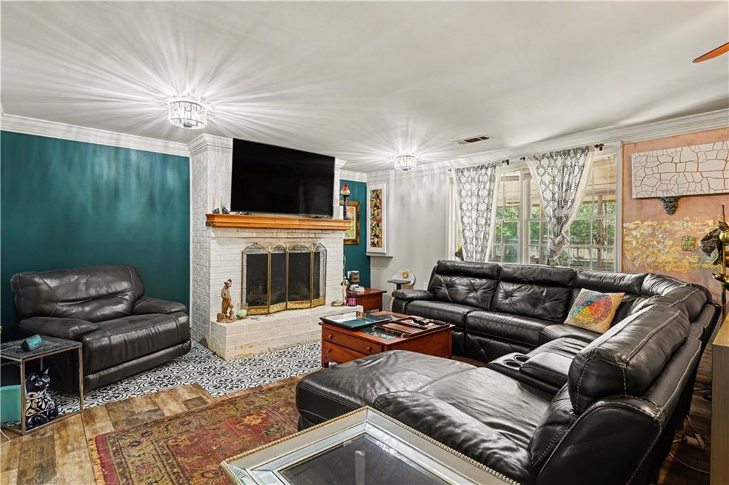 267 Macon Street Monticello, GA 31064 - Photo 5 of 28 a living room with furniture a flat screen tv and a fireplace