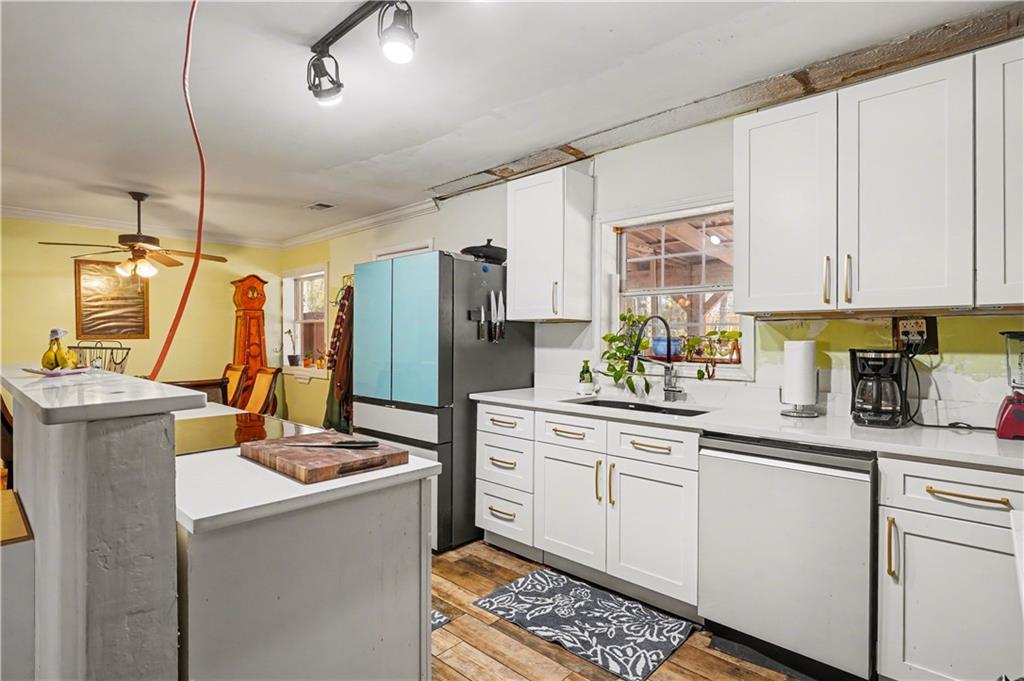 267 Macon Street Monticello, GA 31064 - Photo 8 of 28 a kitchen with a sink appliances and cabinets