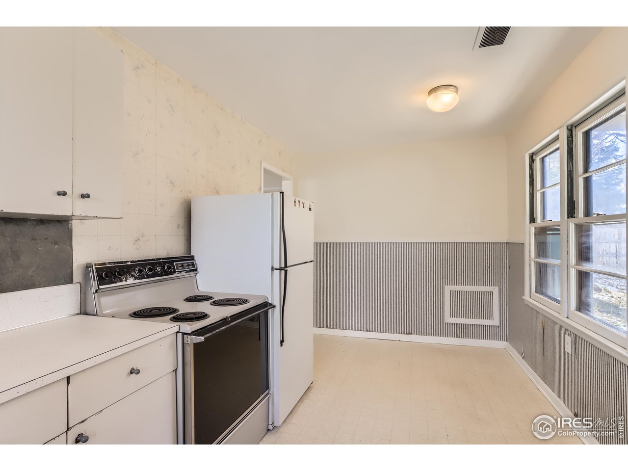 315 29th Street Boulder, CO 80305 - Photo 11 of 29 a kitchen with granite countertop a stove and a refrigerator