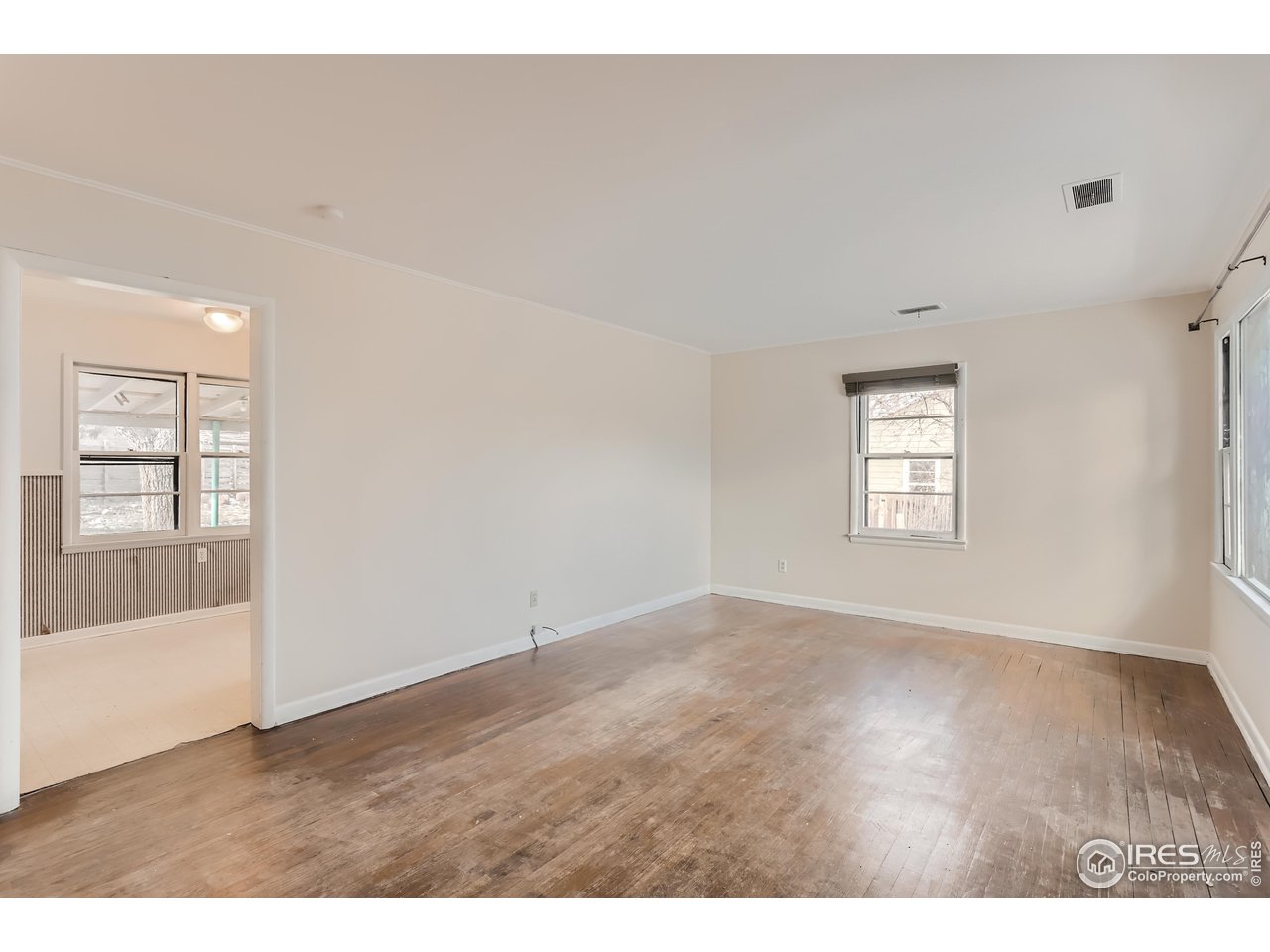 315 29th Street Boulder, CO 80305 - Photo 5 of 29 a view of an empty room with a window and wooden floor