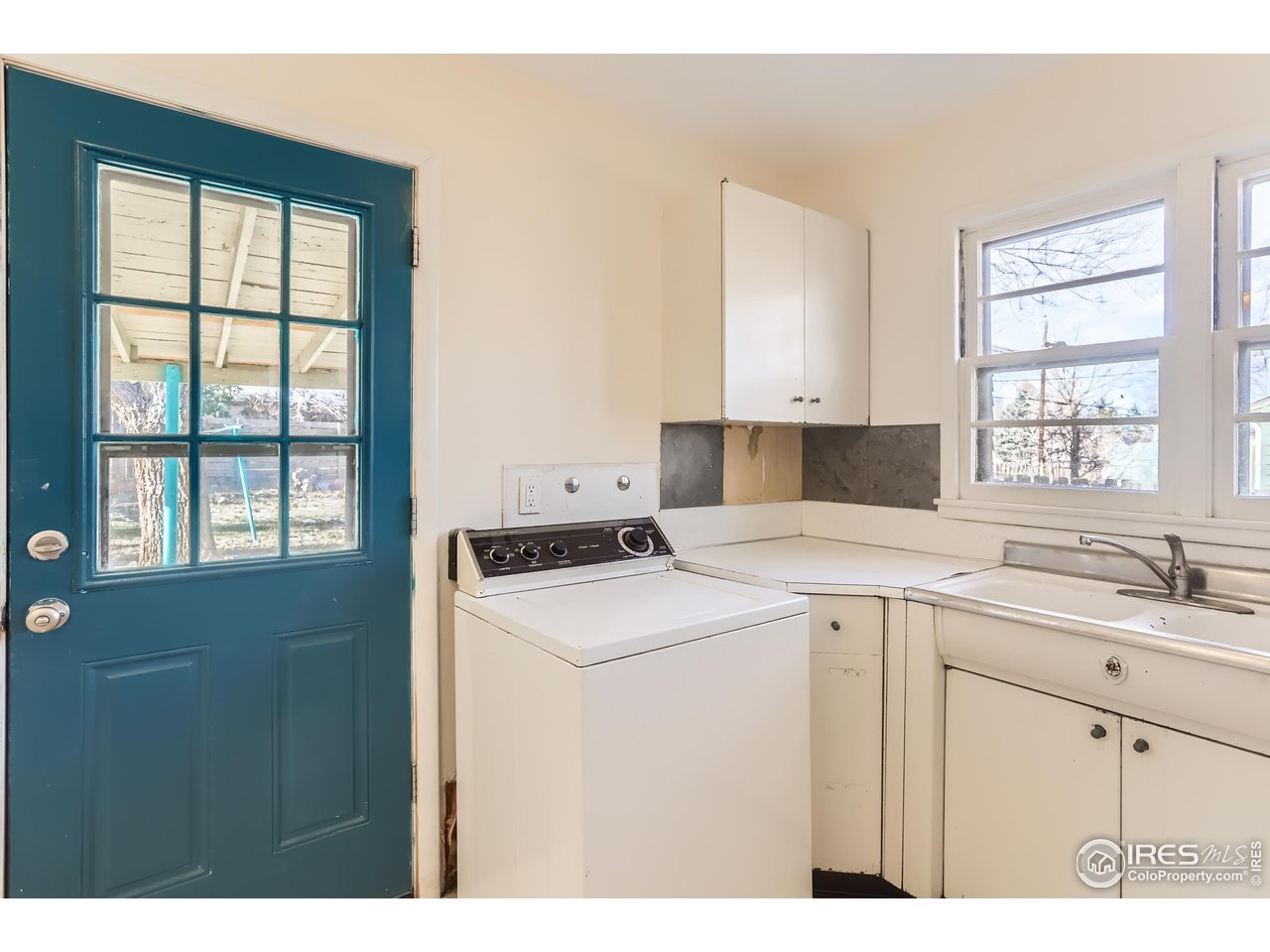 315 29th Street Boulder, CO 80305 - Photo 10 of 29 a kitchen with a stove a sink a window and cabinets